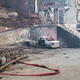 A scorched vehicle sits next to a burned out building in Gatlinburg, Tennessee. (Image: AP)